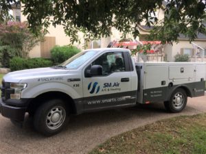 SM Air company truck parked in a driveway.