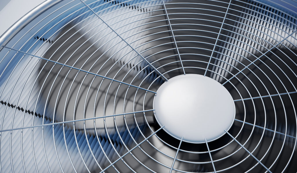 Close-up view on AC unit fan blades spinning.