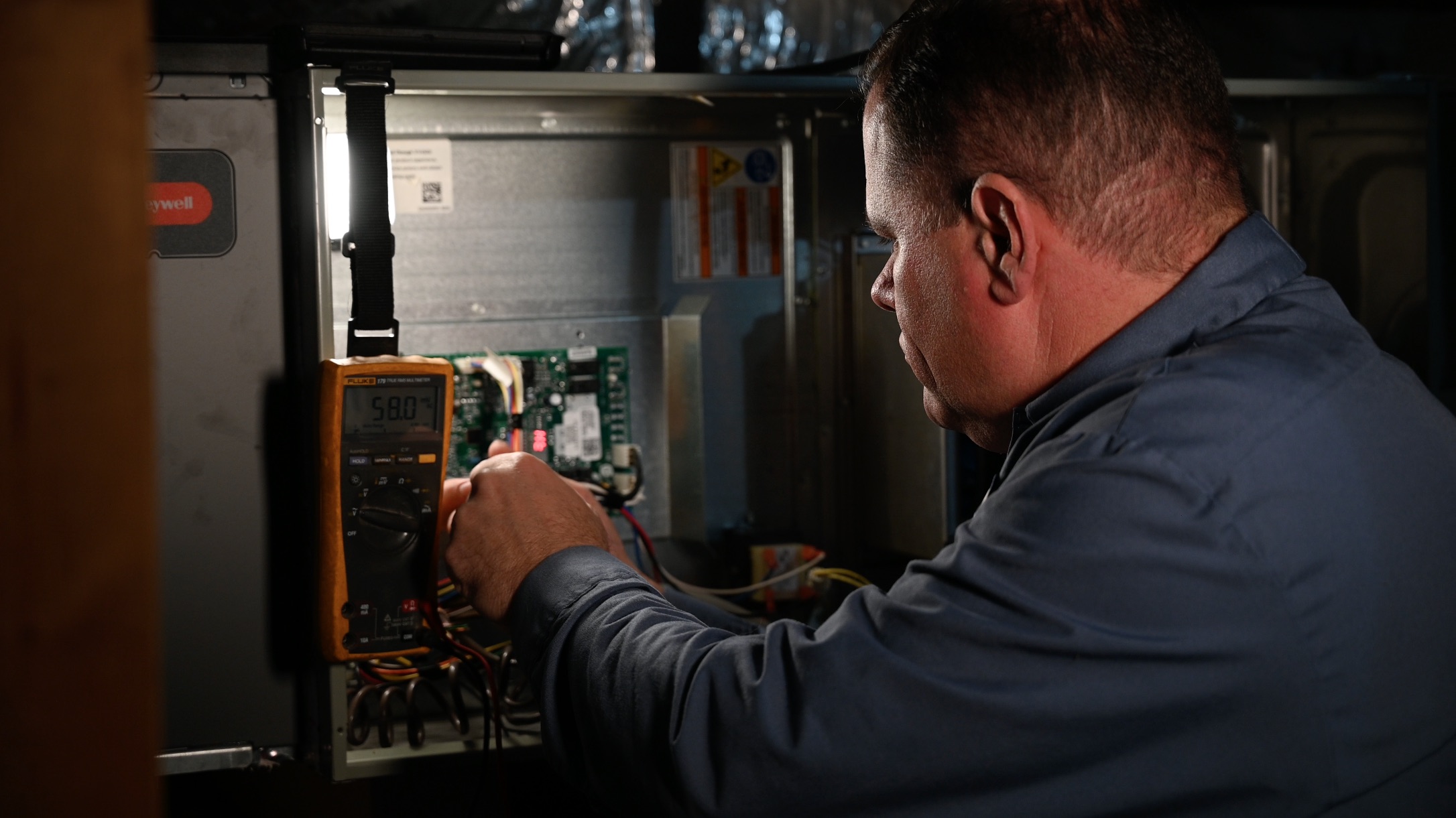 SM Air tech inspecting a furnace in a Reedville TX home. 