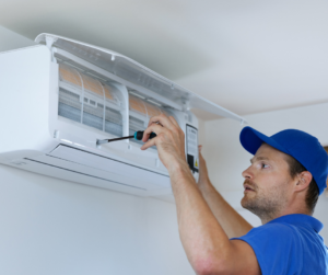 An SM Air maintenance tech working on a ductless hvac unit in San Marcos, TX